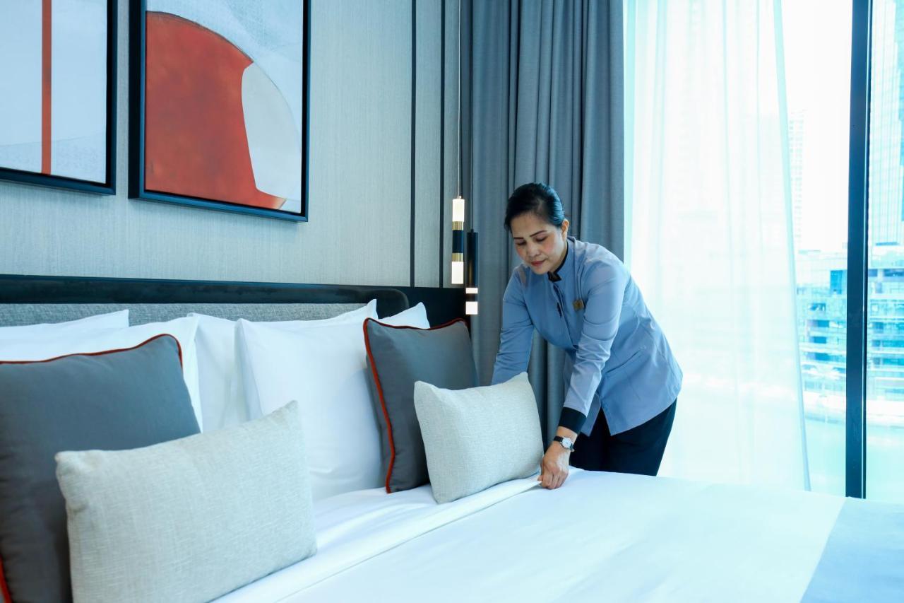 Hotel Charthouse Bahrain Al Manamah Esterno foto A chambermaid making a bed