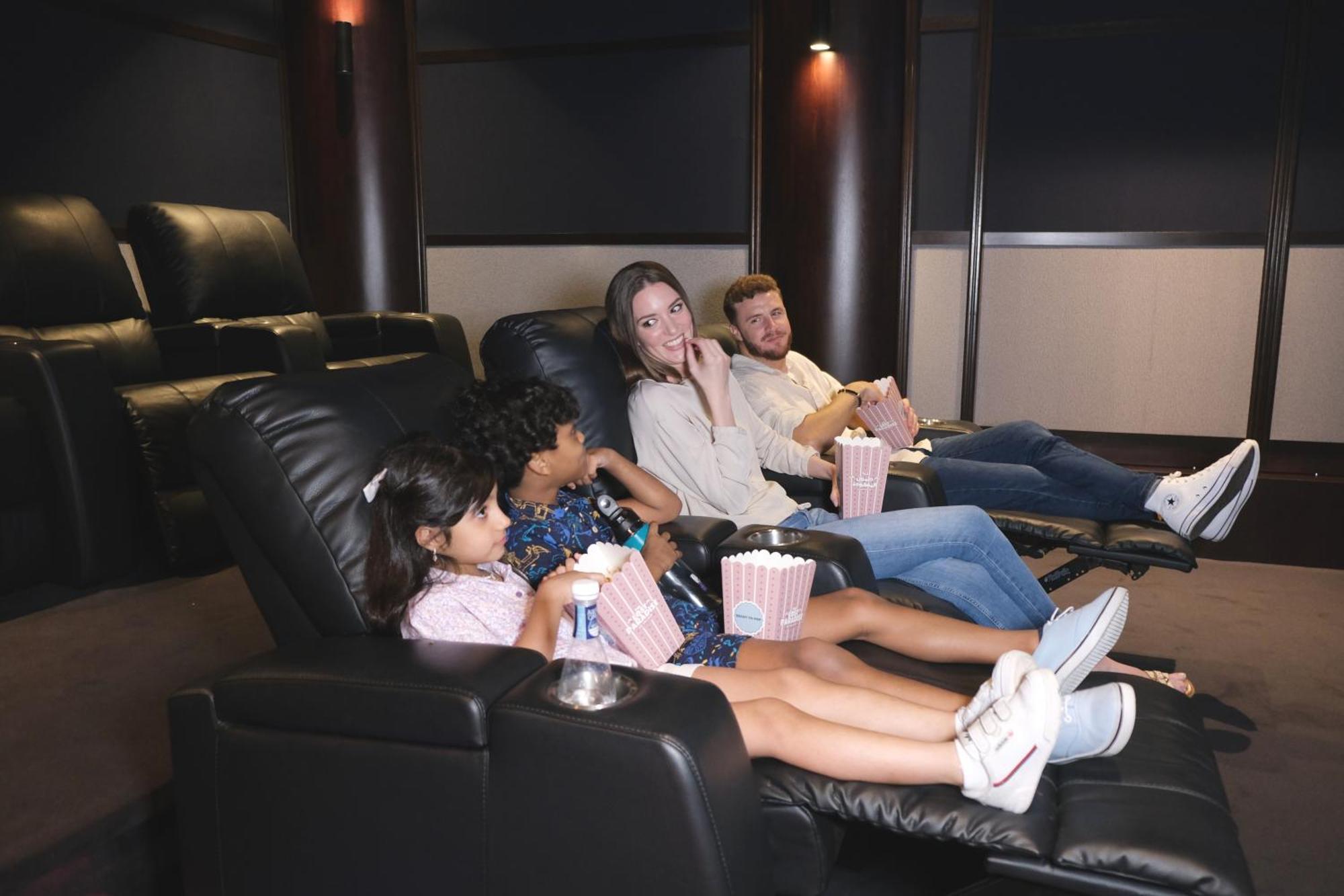 Hotel Charthouse Bahrain Al Manamah Esterno foto A family watching a movie in a home theater