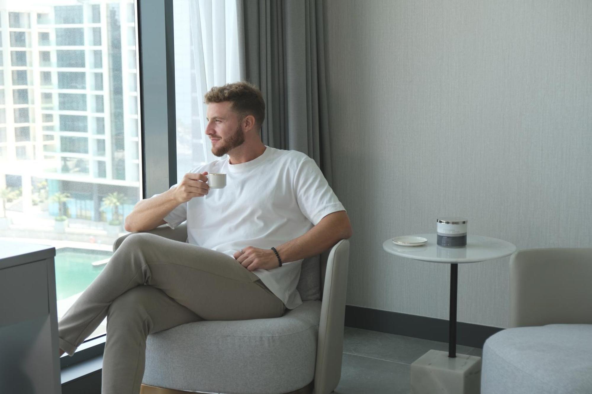 Hotel Charthouse Bahrain Al Manamah Esterno foto A man drinking coffee